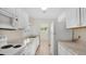 Clean, white kitchen featuring white appliances, ample counter space, and bright tile flooring at 3107 Martinique Way, Orlando, FL 32805