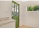 Bright kitchen with light counter tops and a green door with a window at 3107 Martinique Way, Orlando, FL 32805