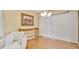 Cozy living room with hardwood flooring, classic chandelier, and a decorative console table at 3107 Martinique Way, Orlando, FL 32805