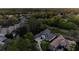 An aerial view showcasing the house nestled within a lush green neighborhood with mature trees at 3334 Park Grove Ct, Longwood, FL 32779