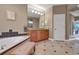 Elegant bathroom featuring a soaking tub, dual sinks, and a separate shower area at 3334 Park Grove Ct, Longwood, FL 32779