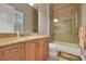 Bathroom featuring a single sink vanity with granite countertop and a tiled shower and bath at 3334 Park Grove Ct, Longwood, FL 32779