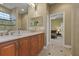 Bright bathroom showcasing double sink vanity with granite countertop, tile floor, and shower at 3334 Park Grove Ct, Longwood, FL 32779