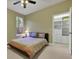 Cozy bedroom featuring a large window, ceiling fan, and an organized closet with built-in shelving and drawers at 3334 Park Grove Ct, Longwood, FL 32779