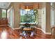 Breakfast nook with large window, hardwood floors, and outdoor view, adjacent to kitchen at 3334 Park Grove Ct, Longwood, FL 32779