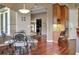 Open dining area with hardwood floors features a marble table and decorative lighting and cabinetry at 3334 Park Grove Ct, Longwood, FL 32779