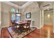 Elegant dining room with a wood table, detailed rug, and archways offering a spacious feel at 3334 Park Grove Ct, Longwood, FL 32779