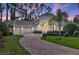 Elegant home with manicured landscaping, a brick driveway, and a three-car garage at 3334 Park Grove Ct, Longwood, FL 32779