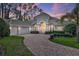 Stunning home with a circular driveway, manicured landscaping, and a two-car garage at 3334 Park Grove Ct, Longwood, FL 32779