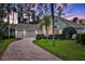 Lovely exterior shot of the home showing the well-manicured lawn and attractive three-car garage at 3334 Park Grove Ct, Longwood, FL 32779