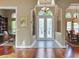 Elegant foyer with frosted double doors, chandelier lighting, and hardwood flooring at 3334 Park Grove Ct, Longwood, FL 32779