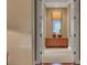 View through the hallway showing a cabinet with a window and light coming through at 3334 Park Grove Ct, Longwood, FL 32779