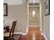 Inviting hallway with hardwood floors, neutral walls, decorative niche, and elegant trim detailing throughout at 3334 Park Grove Ct, Longwood, FL 32779