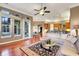 Open concept living room featuring natural light, hardwood floors, and seamless flow to the kitchen at 3334 Park Grove Ct, Longwood, FL 32779