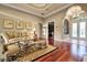 Cozy living room featuring hardwood floors, a tray ceiling, and ample natural light at 3334 Park Grove Ct, Longwood, FL 32779