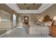 Large main bedroom with tray ceiling showing closet access and view to the ensuite bathroom at 3334 Park Grove Ct, Longwood, FL 32779