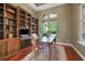 Home office featuring built-in bookshelves, a large desk, and natural light at 3334 Park Grove Ct, Longwood, FL 32779