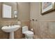 Clean powder room with pedestal sink and tiled walls with chair rail at 3334 Park Grove Ct, Longwood, FL 32779