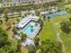 An aerial view of the community clubhouse, pool, tennis courts, and grounds at 3415 Sagebrush St, Harmony, FL 34773