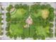 Aerial view of community park featuring green spaces, trees, and playground equipment at 3415 Sagebrush St, Harmony, FL 34773