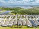 Aerial view highlighting the home's location in a neighborhood near a lake, solar panels, and green spaces at 3415 Sagebrush St, Harmony, FL 34773