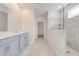 Well-lit bathroom with a walk-in shower, tile, and dual vanity at 3415 Sagebrush St, Harmony, FL 34773