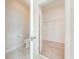 Well lit bathroom leading to a carpeted walk-in closet with wire shelving at 3415 Sagebrush St, Harmony, FL 34773