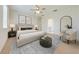Airy bedroom featuring a ceiling fan, accent chair, and serene decor at 3415 Sagebrush St, Harmony, FL 34773