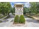 Community entrance sign with amenities listed, lush landscaping, and tree-lined street at 3415 Sagebrush St, Harmony, FL 34773