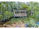 Scenic view of a wooden lookout over a marshy pond abundant with lily pads and lush vegetation at 3415 Sagebrush St, Harmony, FL 34773