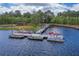 Aerial view of a boat dock on a lake with several boats docked and a wooden walkway at 3415 Sagebrush St, Harmony, FL 34773