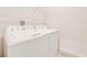 Convenient laundry room with a white washer, dryer, and overhead shelving at 3415 Sagebrush St, Harmony, FL 34773