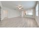 Spacious living room with wood-look tile and a view into the kitchen at 3415 Sagebrush St, Harmony, FL 34773