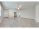 Open living room with light walls and wood-look tile flooring at 3415 Sagebrush St, Harmony, FL 34773