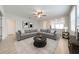 Spacious living room featuring an area rug, stylish decor, and a ceiling fan at 3415 Sagebrush St, Harmony, FL 34773