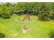 Aerial view of modern red sculpture garden located on property's beautiful lush green grounds at 3415 Sagebrush St, Harmony, FL 34773