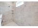 This shower features gray, square tiling with two corner shelves and a window at 3415 Sagebrush St, Harmony, FL 34773