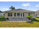 Back exterior view featuring a patio with a lush green lawn at 346 Vista Oaks Way, Davenport, FL 33837