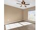 Bright bedroom featuring hardwood floors, a large window, and overhead fan with lighting at 346 Vista Oaks Way, Davenport, FL 33837