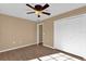 Comfortable bedroom featuring a ceiling fan, wood flooring, and a double door closet at 346 Vista Oaks Way, Davenport, FL 33837