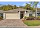 Charming single-story home with brick driveway, lush landscaping, and inviting entryway at 346 Vista Oaks Way, Davenport, FL 33837