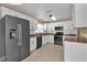 Clean kitchen featuring white cabinets, modern appliances, and tile flooring at 346 Vista Oaks Way, Davenport, FL 33837