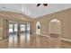 Spacious living room features tile flooring, light neutral walls, large sliding glass doors and modern lighting at 346 Vista Oaks Way, Davenport, FL 33837