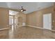 Open-concept living room boasts tile flooring, neutral walls, and plenty of natural light at 346 Vista Oaks Way, Davenport, FL 33837