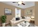 Cozy living room featuring a comfortable couch, light colored walls, and art at 346 Vista Oaks Way, Davenport, FL 33837