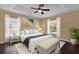 Comfortable bedroom with hardwood floors, accent wall art, and natural lighting at 346 Vista Oaks Way, Davenport, FL 33837