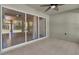 Covered patio area with sliding glass doors and tile flooring at 346 Vista Oaks Way, Davenport, FL 33837