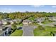 Street view of homes featuring well-manicured lawns and mature trees at 346 Vista Oaks Way, Davenport, FL 33837