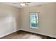 Cozy bedroom with modern ceiling fan and a bright window view at 3734 Safflower Terrace, Oviedo, FL 32766