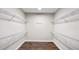 Walk-in closet featuring wire shelving and hardwood floors at 3734 Safflower Terrace, Oviedo, FL 32766